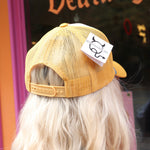 A woman wearing the Not Slim Kinda Shady Trucker Hat in front of a window, showing off the back.