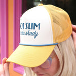An up close image of a woman wearing the Not Slim Kinda Shady Trucker Hat in front of a window.