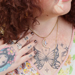 A woman wearing the Opalite Crescent Necklace – Gold Chain Crystal Moon Pendant.