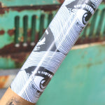The Eye Waves Pattern Matte Fine Wrapping Paper in front of a vintage teal Volkswagen bus.