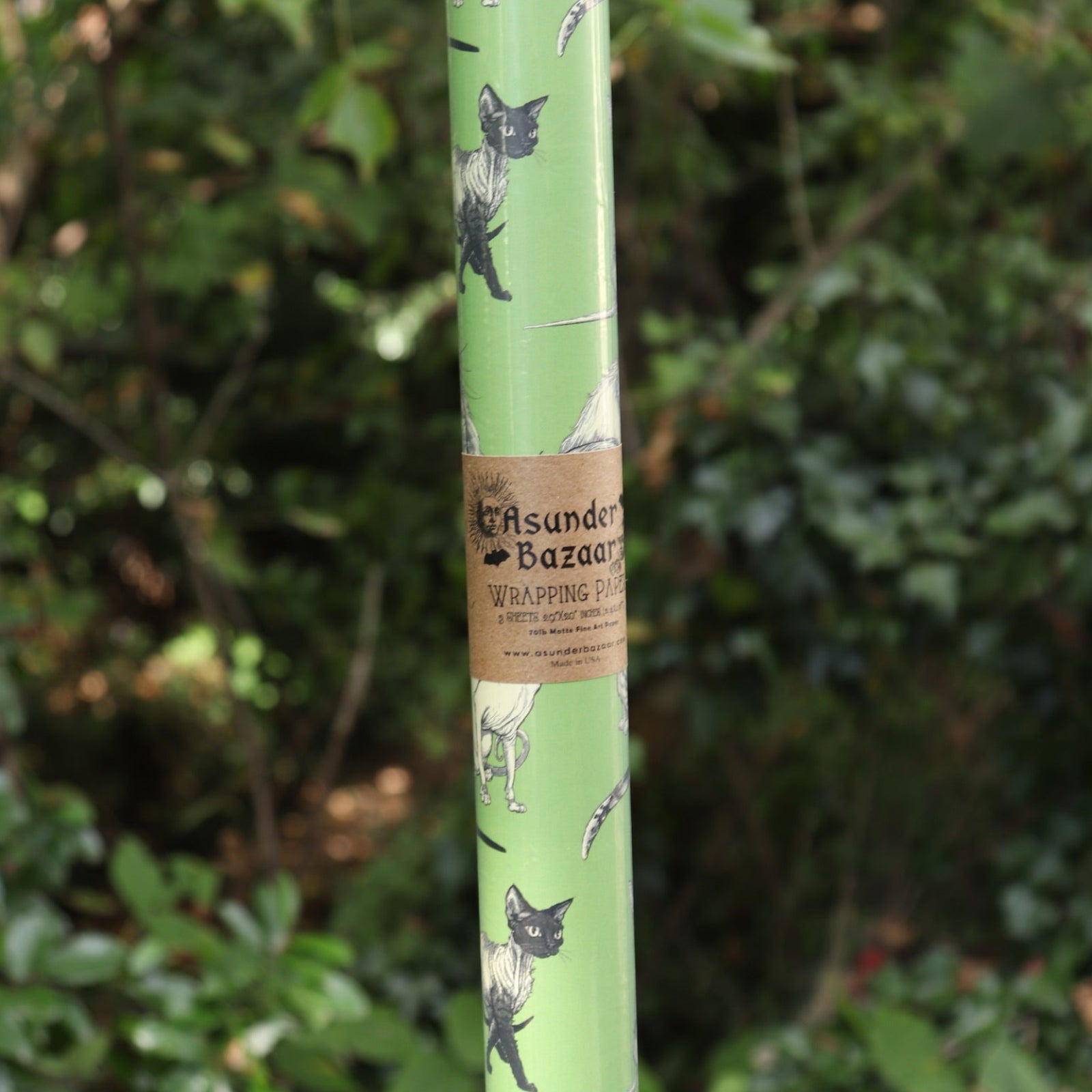 The Illustrated Cat Breeds Matte Fine Wrapping Paper in front of greenery.
