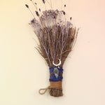 The Moon Besom Broom with Clear Quartz on a pink and yellow background.
