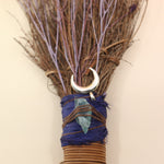 The Moon Besom Broom with Clear Quartz on a pink and yellow background.