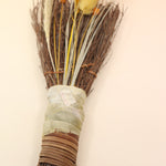 The Cinnamon Besom Broom with Quartz Healing Crystal on a pink and yellow background.