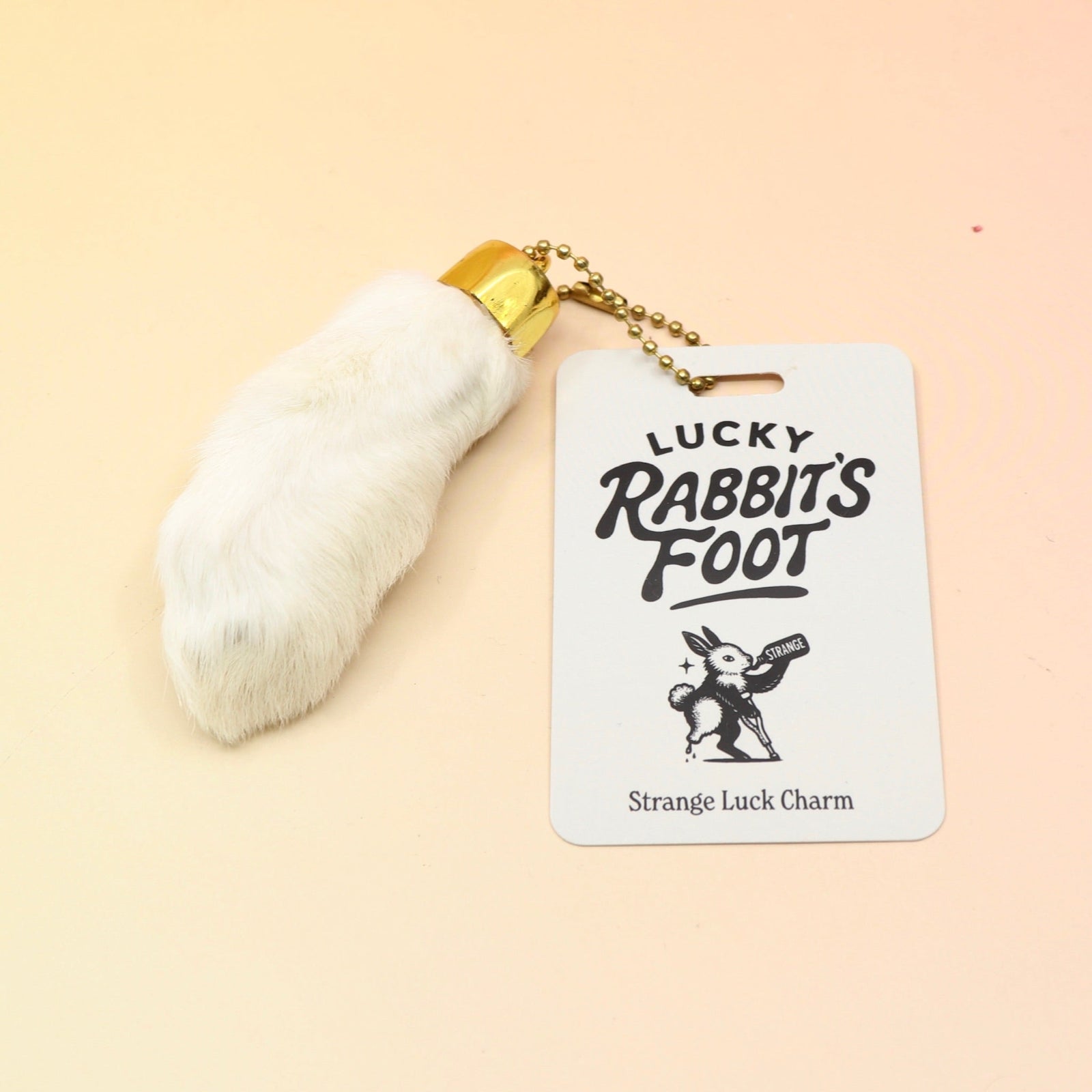 The Lucky Rabbit's Foot on a pink and yellow background.