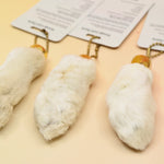 Three of the Lucky Rabbit's Foot on a pink and yellow background.