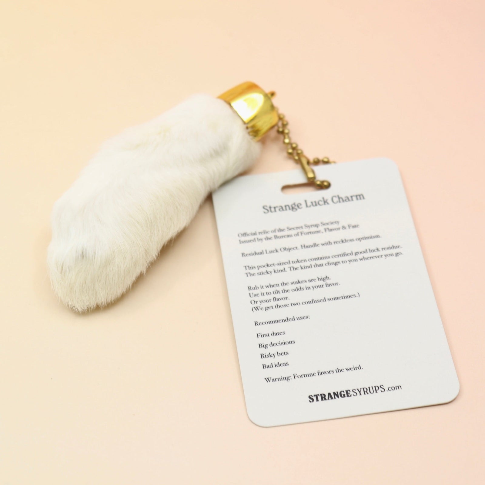 The Lucky Rabbit's Foot on a pink and yellow background.