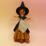 The dress Witch Samhain Folk Corn Husk Poppet Doll on a pink and yellow background. 