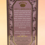 The Wild Rose Premium Incense on a pink and yellow background, showing off the back.