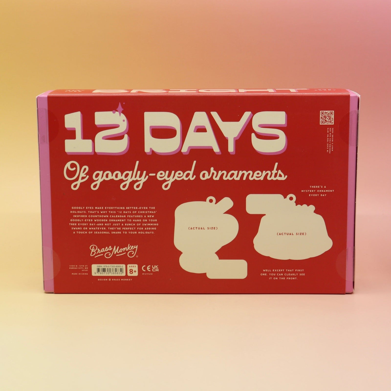 The back of the Googly & Bright Holiday Advent Calendar on a pink and yellow background.