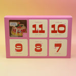 The Googly & Bright Holiday Advent Calendar on a pink and yellow background.