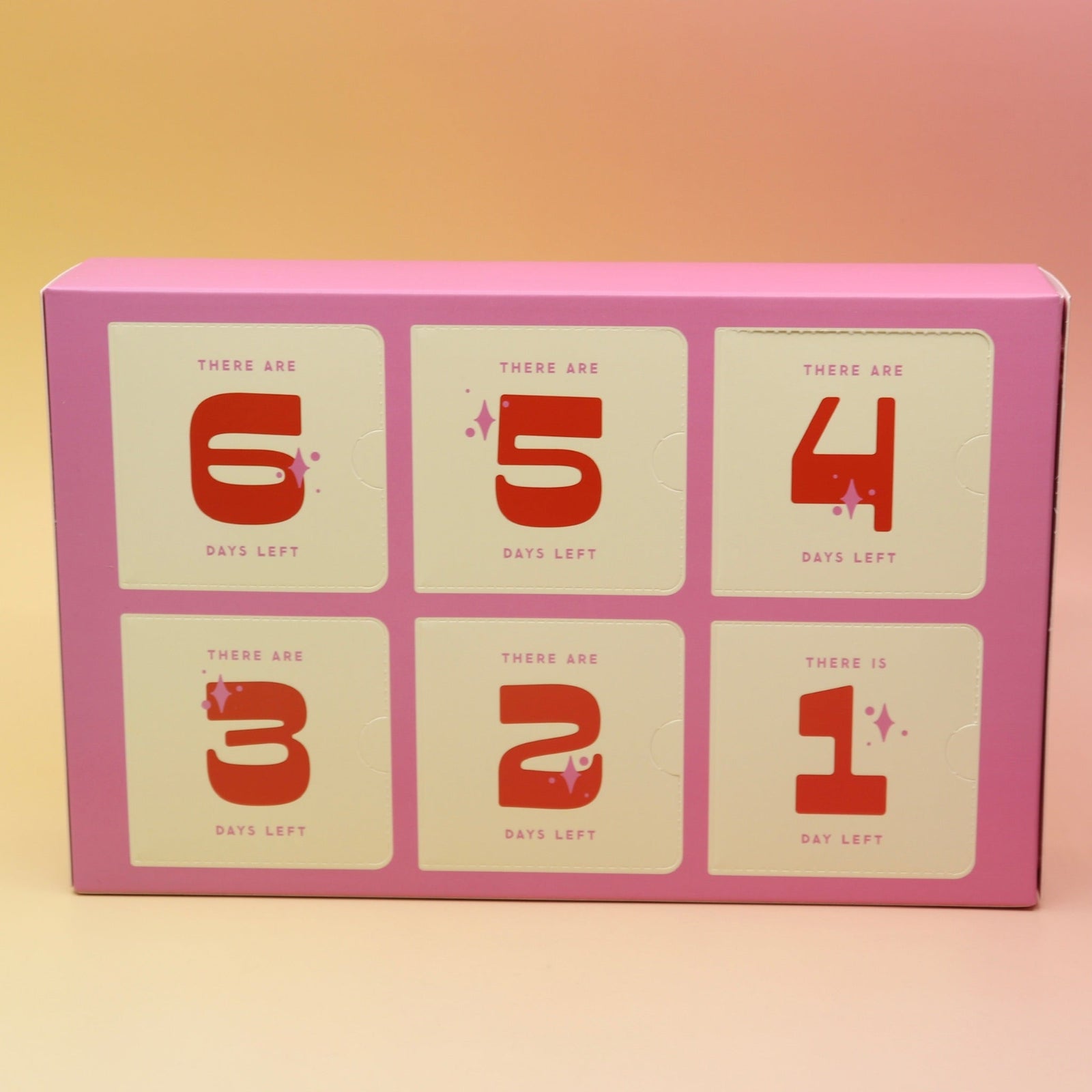 The Googly & Bright Holiday Advent Calendar on a pink and yellow background.