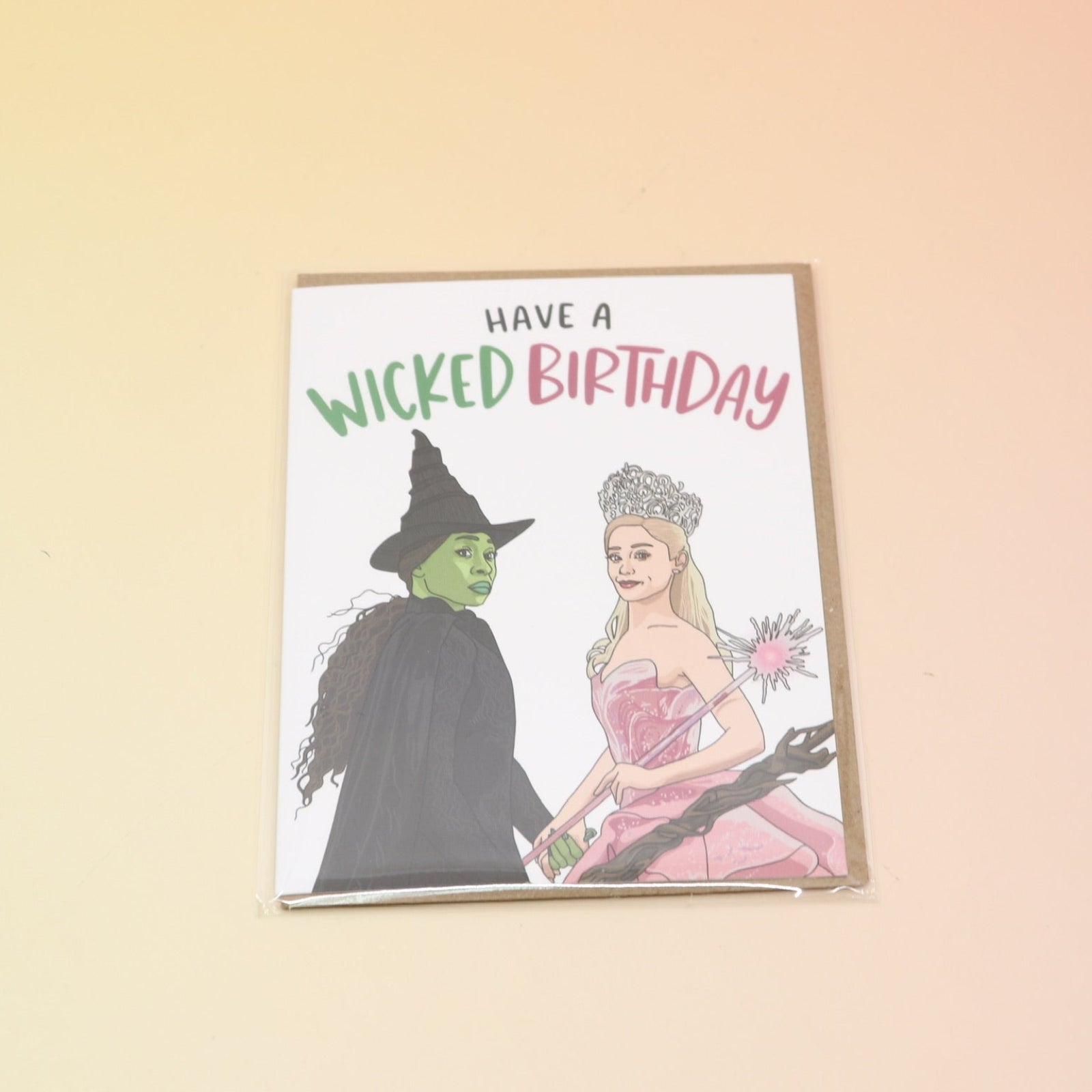 The Have A Wicked Birthday Card on a pink and yellow background.