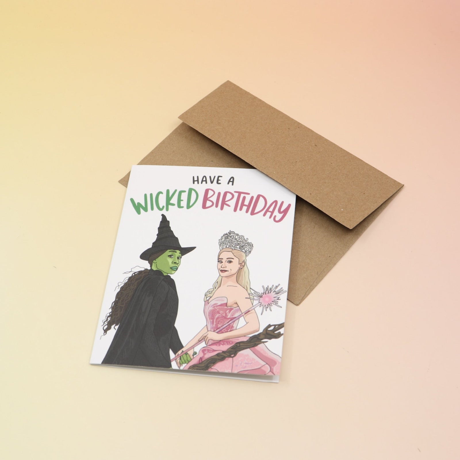 The Have A Wicked Birthday Card and its envelope on a pink and yellow background.