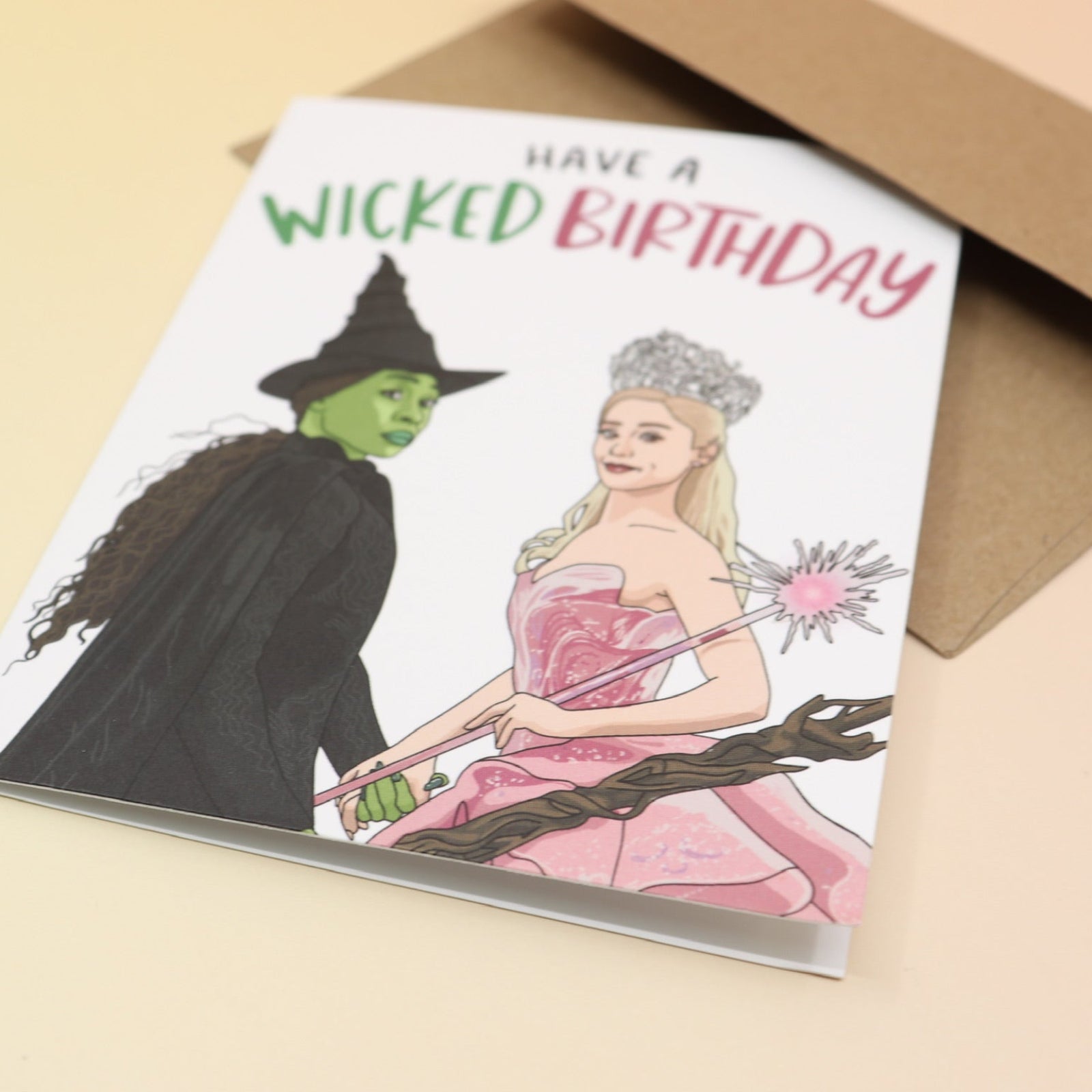 The Have A Wicked Birthday Card and its envelope on a pink and yellow background.