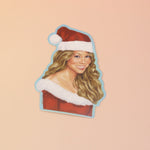 The Mariah Carey Christmas Sticker on a pink and yellow background.