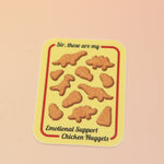 The Emotional Support Nuggets Vinyl Sticker on a pink and yellow background.