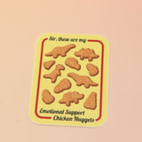 The Emotional Support Nuggets Vinyl Sticker on a pink and yellow background.