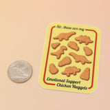 The Emotional Support Nuggets Vinyl Sticker on a pink and yellow background.