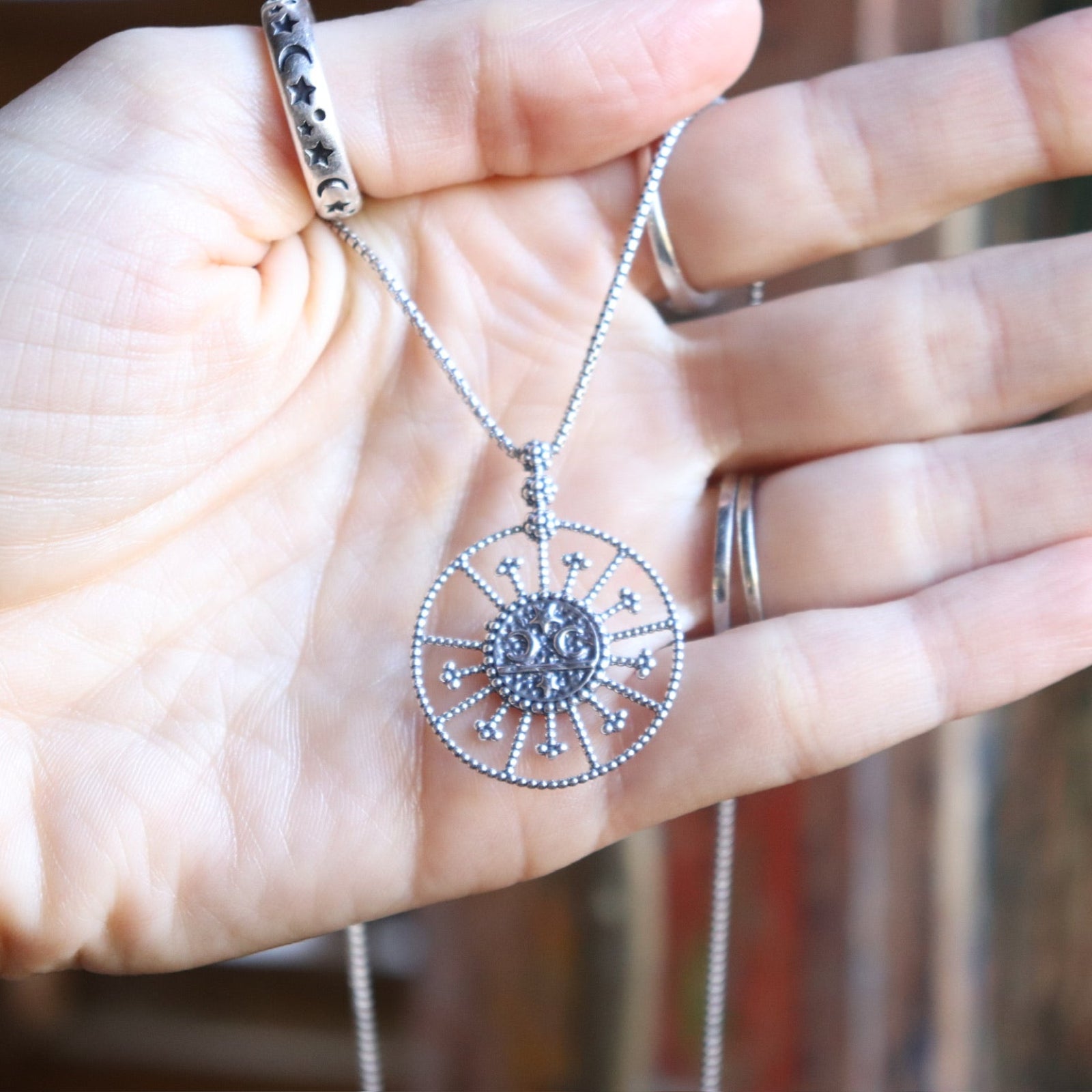 Someone holding the Morgana's Spell Sterling Silver Necklace.
