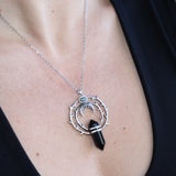 Someone wearing the Silver Thorn Crystal Necklace with a black tank.