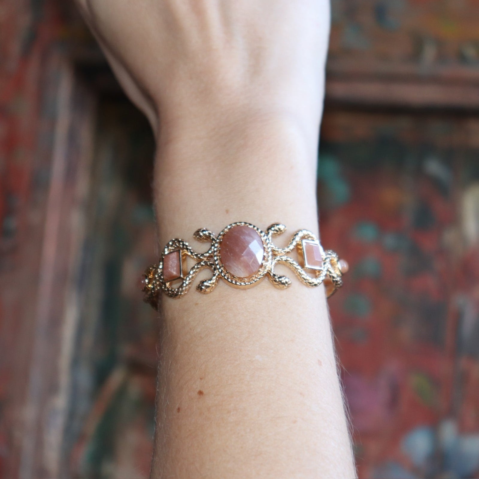 Someone wearing the Gold Medusa Cuff Bracelet.