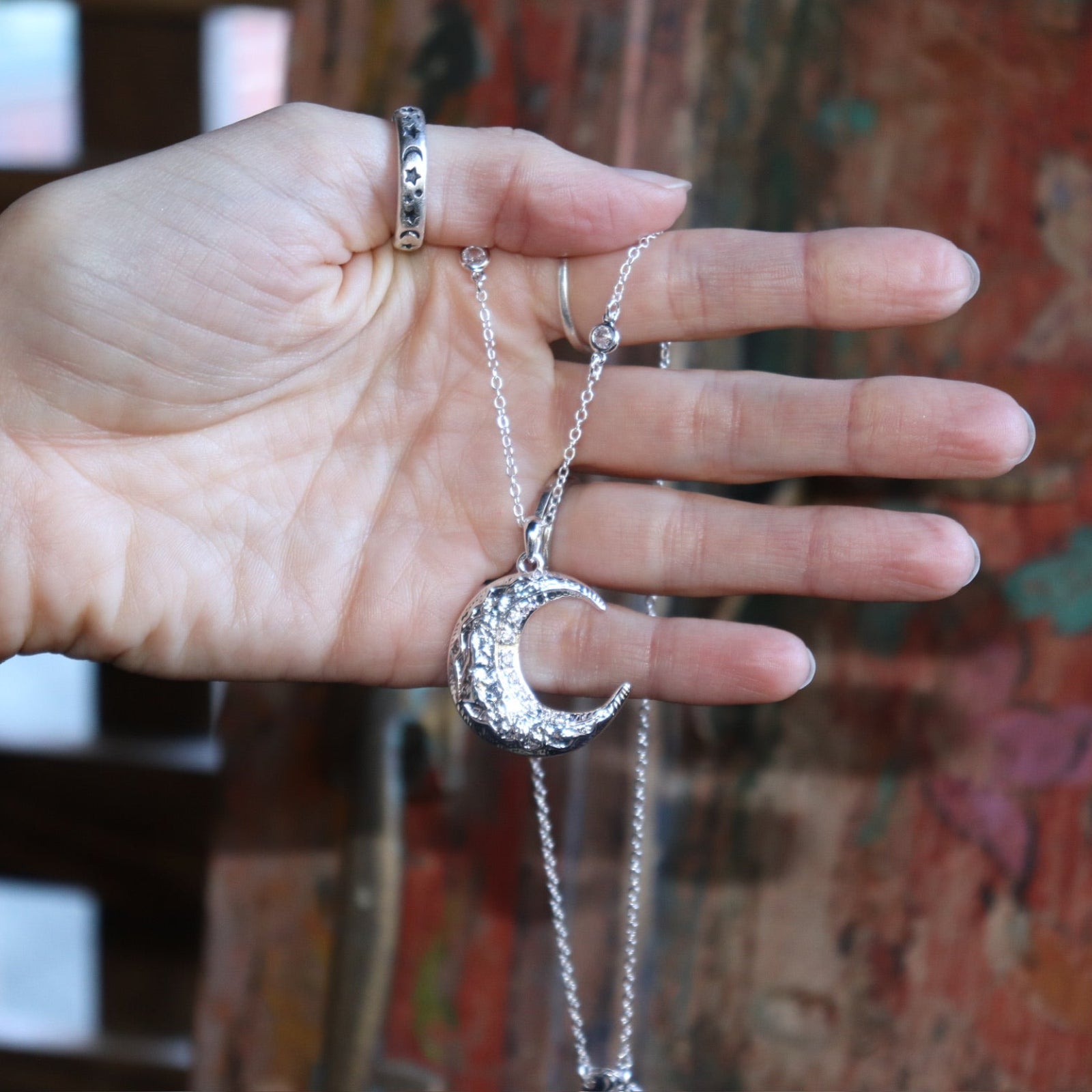 Someone holding the The Hare Moon Silver Necklace.