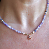 Someone wearing the the Beaded Sea Compass Necklace.