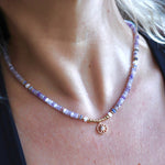 Someone wearing the the Beaded Sea Compass Necklace.