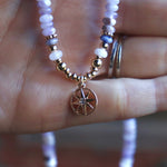 Someone holding the the Beaded Sea Compass Necklace.