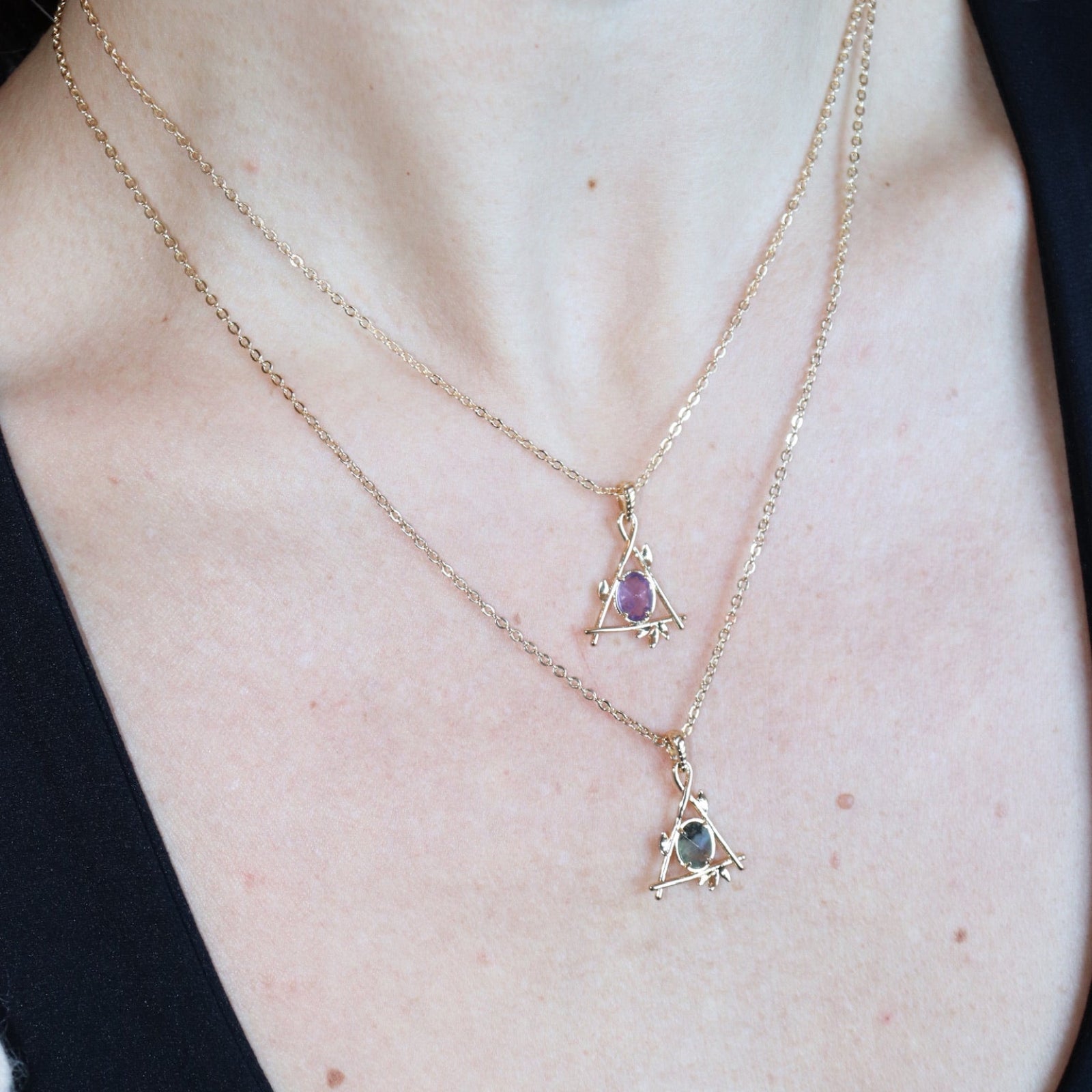 Someone wearing the amethyst and labradorite Fae Crystal Gold Necklaces.