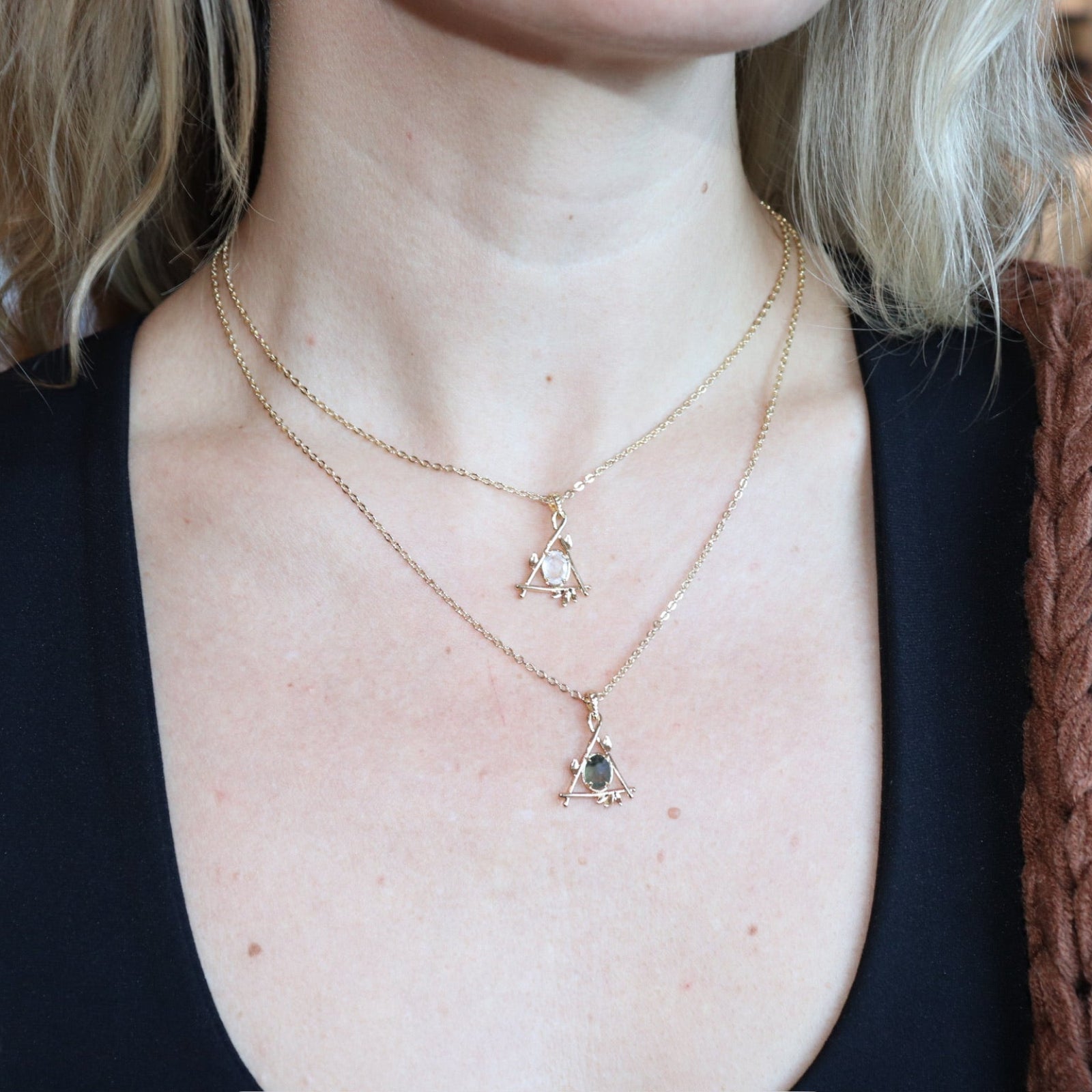 A woman wearing the quartz and labradorite Fae Crystal Gold Necklaces.