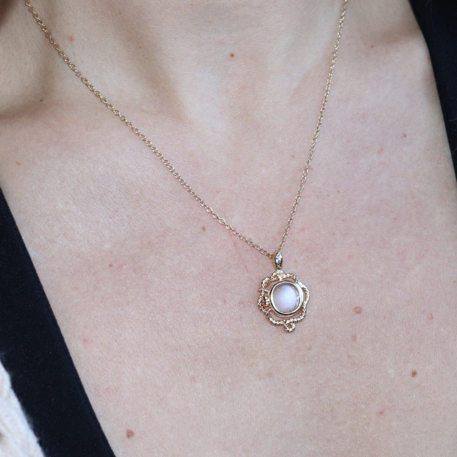 Someone wearing the Lilith Keepsake Gold Necklace with black tank top.