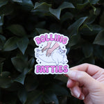 Someone the Rolling Fatties Funny Cat Sticker in front of a green bush.