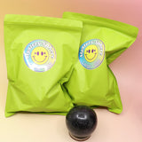 Two of the large Mystery Crystal Sphere Bags on a pink and yellow background.