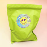 A large Mystery Crystal Sphere Bag on a pink and yellow background.