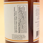 The Hot Toddy Cocktail Mixer and Mocktail Mixer on a pink and yellow background.