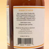 The Hot Toddy Cocktail Mixer and Mocktail Mixer on a pink and yellow background.