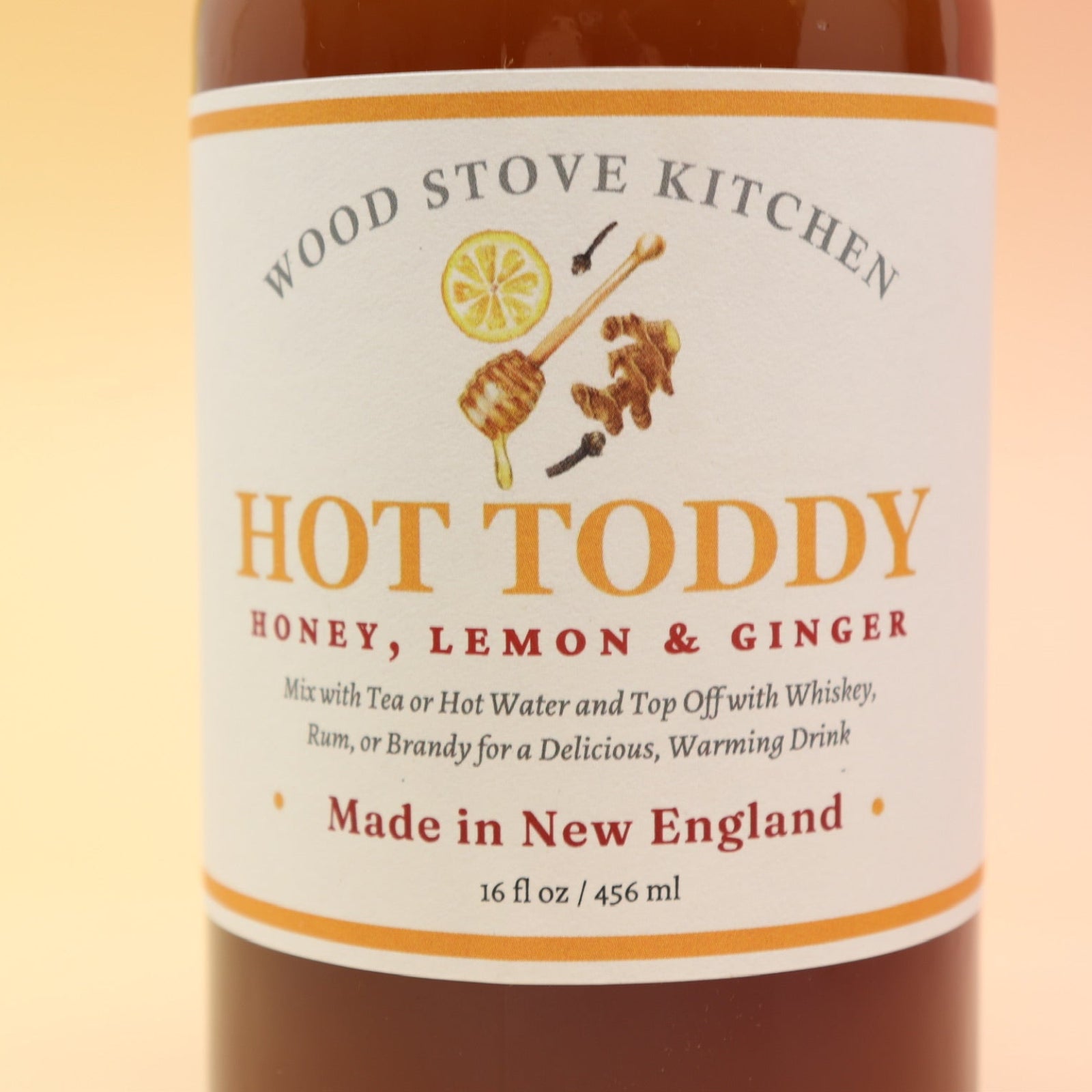 The Hot Toddy Cocktail Mixer and Mocktail Mixer on a pink and yellow background.