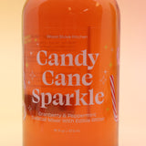 The Candy Cane Sparkle Cocktail & Mocktail Mixer on a pink and yellow background.