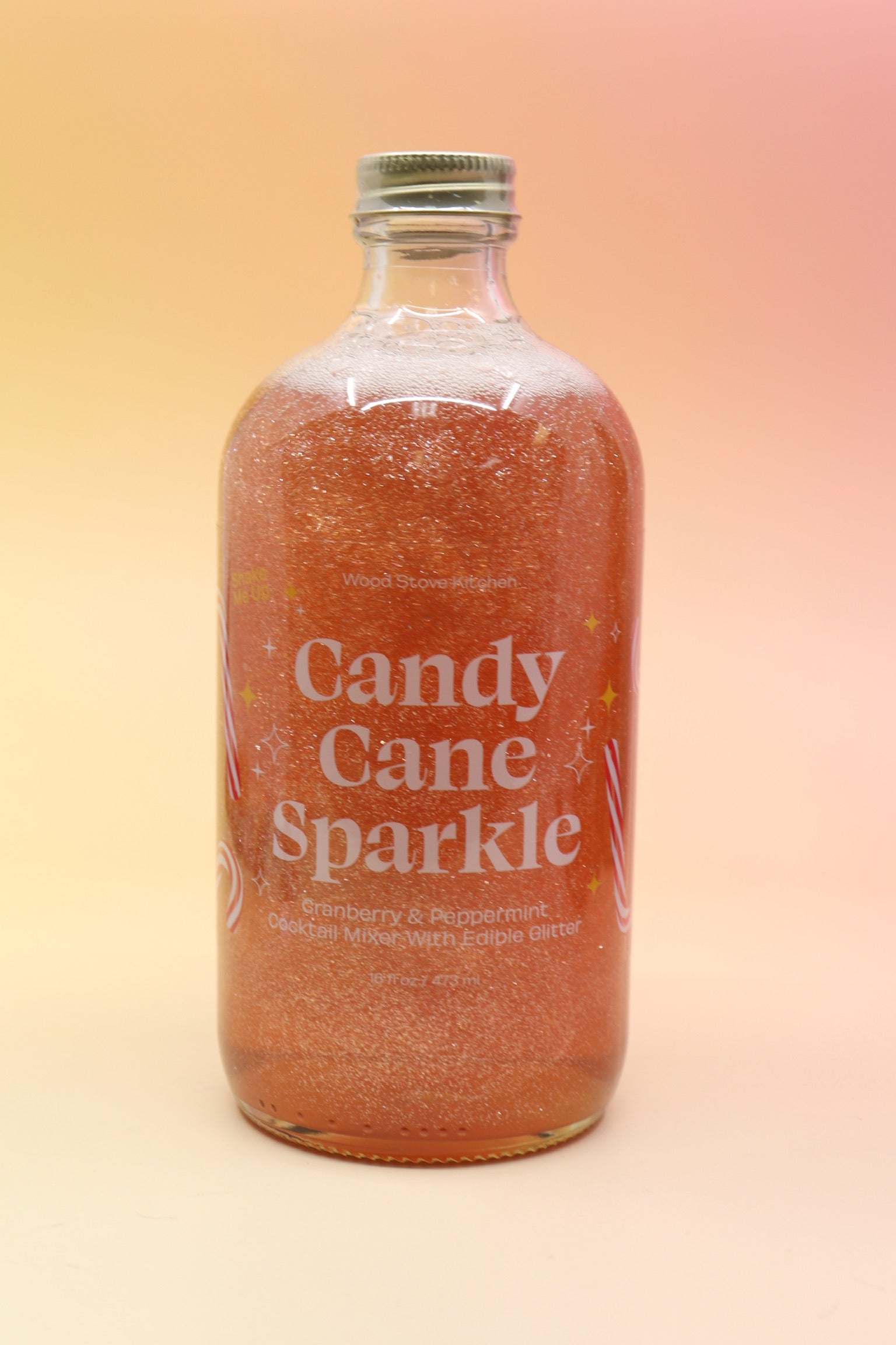 The Candy Cane Sparkle Cocktail & Mocktail Mixer on a pink and yellow background.
