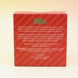 The Naughty or Nice Cotton Candy Drink Glitter Bombs on a pink and yellow background, showing the side.