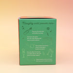 The Naughty or Nice Cotton Candy Drink Glitter Bombs on a pink and yellow background, showing the side.