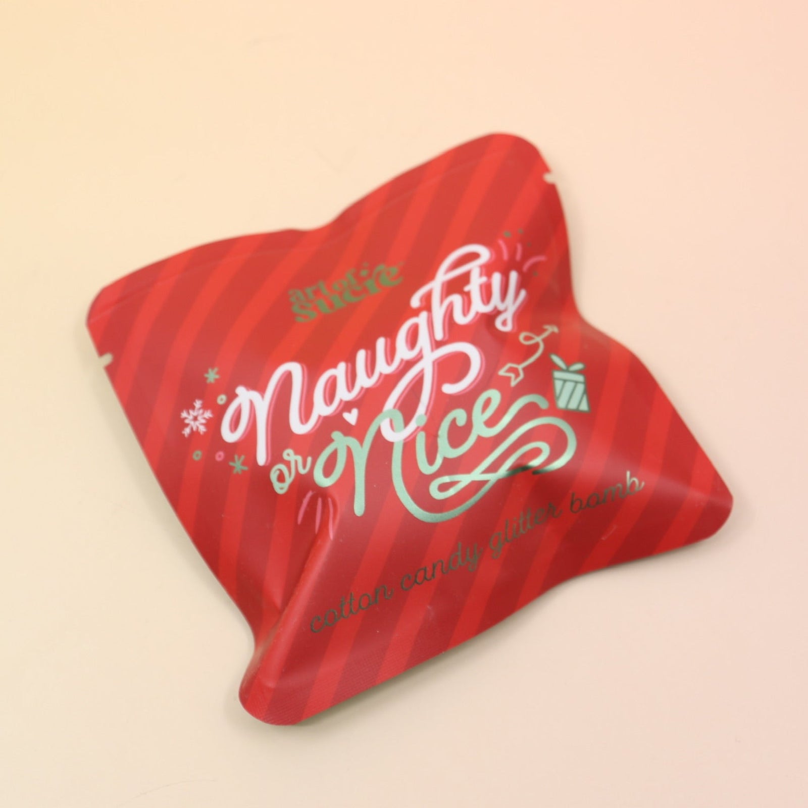 The Naughty or Nice Cotton Candy Drink Glitter Bombs on a pink and yellow background.