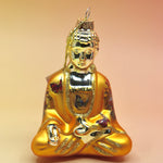 The orange Buddha with Butterfly Glass Ornament on a pink and yellow background.