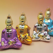 The four colors of the Buddha with Butterfly Glass Ornaments all on. apink and yellow background.