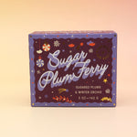 The Sugar Plum Ferry Holiday Bar Soap on a pink and yellow background.
