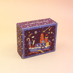 The Sugar Plum Ferry Holiday Bar Soap on a pink and yellow background.