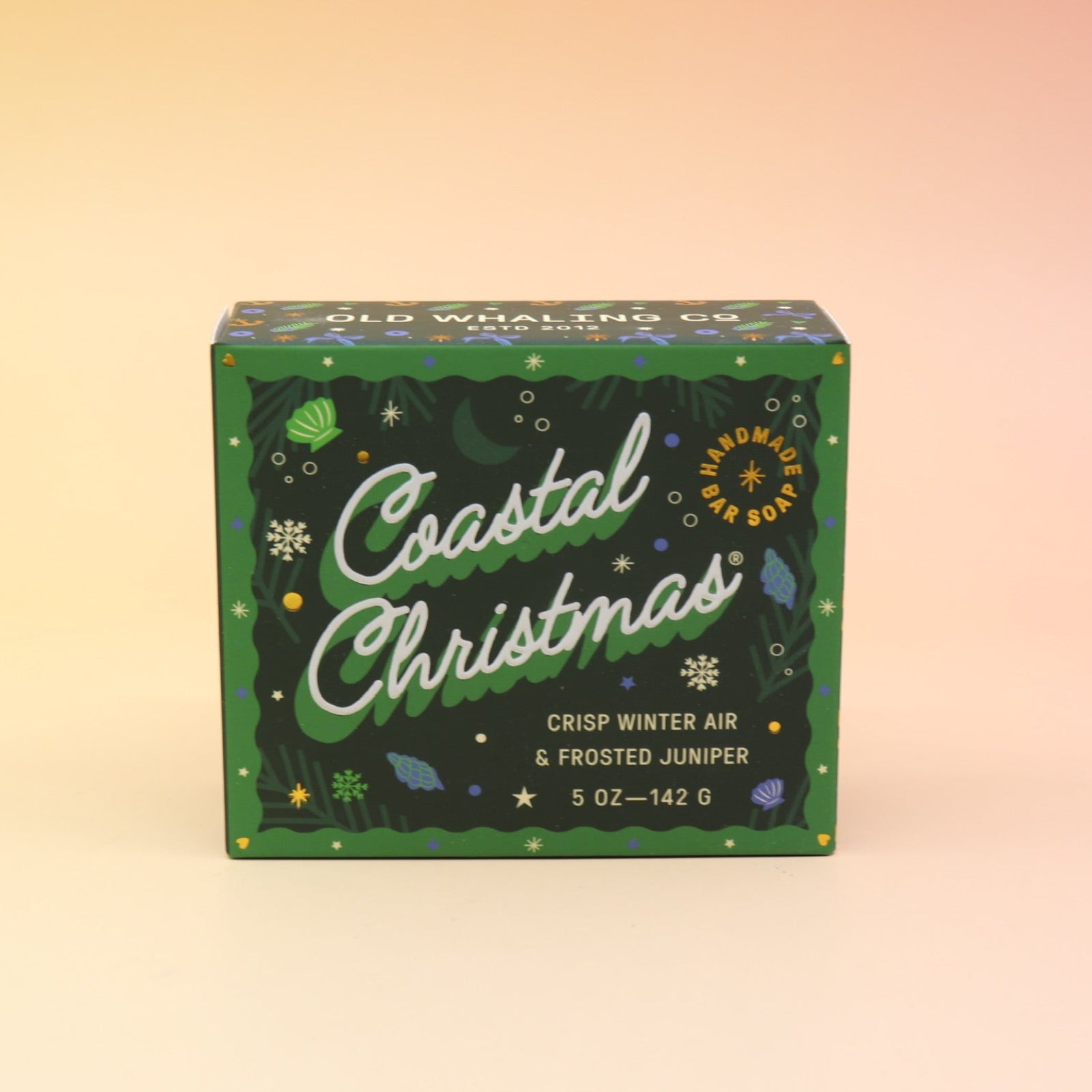 The Coastal Christmas Holiday Bar Soap on a pink and yellow background.