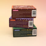 All of the Old Whaling Company Holiday Bar Soaps on a pink and yellow background.